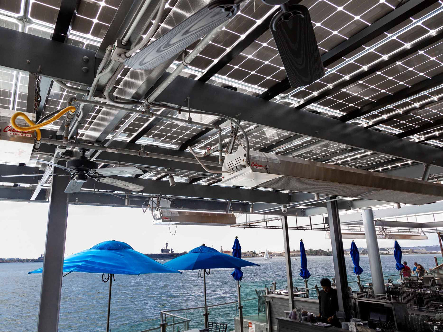 Calcana infrared patio heater mounted on a restaurant pergola, heating guests outdoors