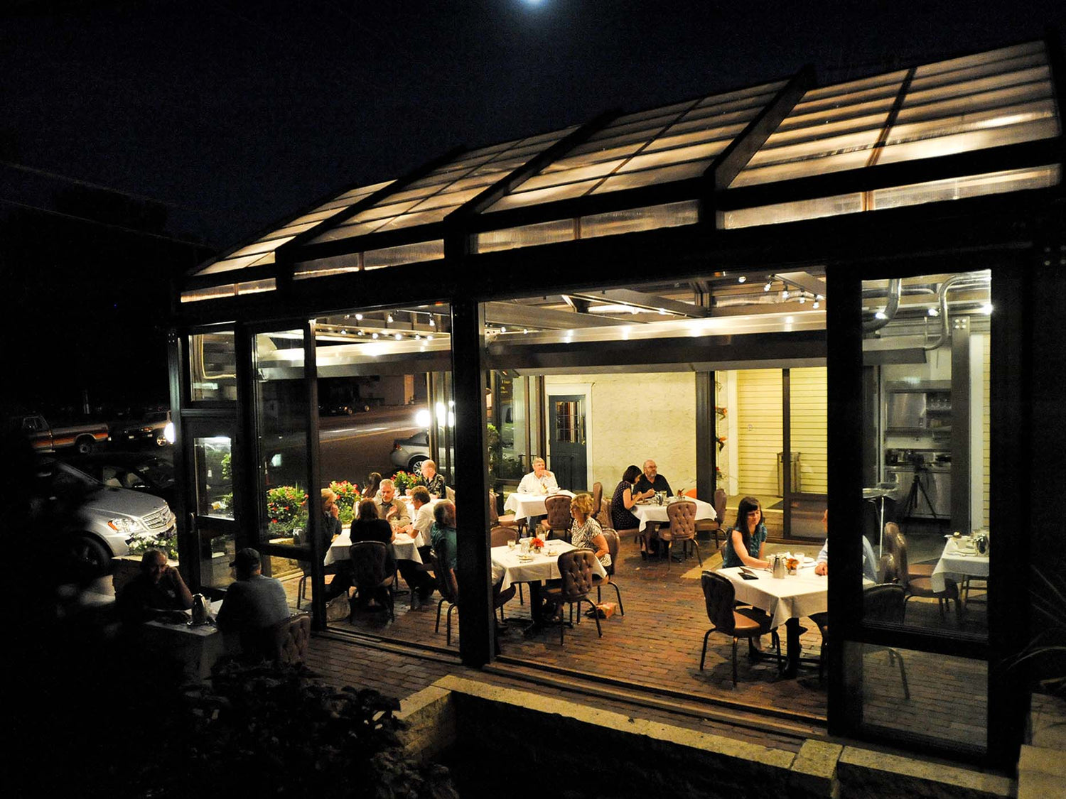 Infrared patio heater warming an enclosed outdoor patio with seating area