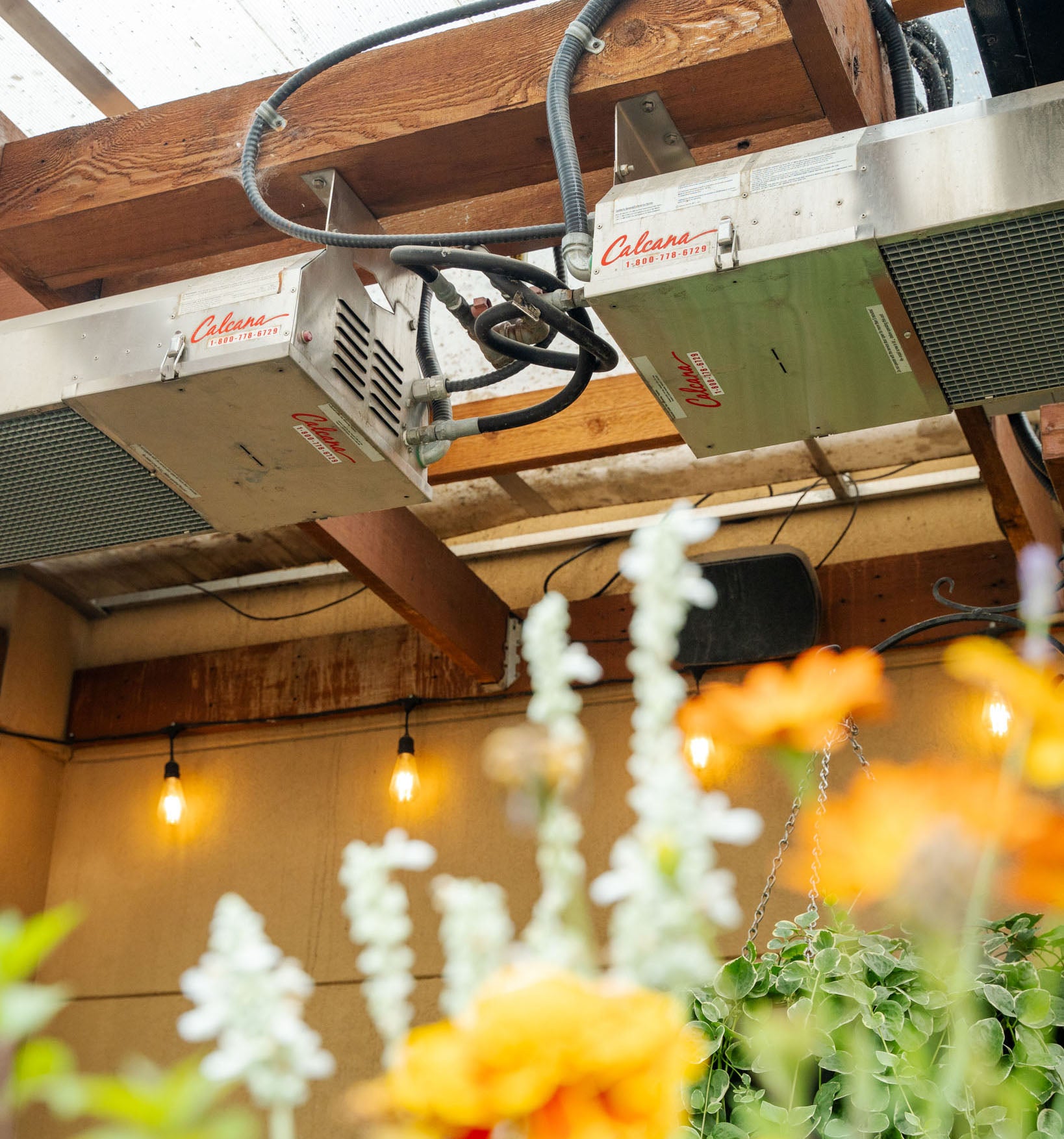 Infrared Patio Heater Burner Head Close Up with Orange Flowers Close By