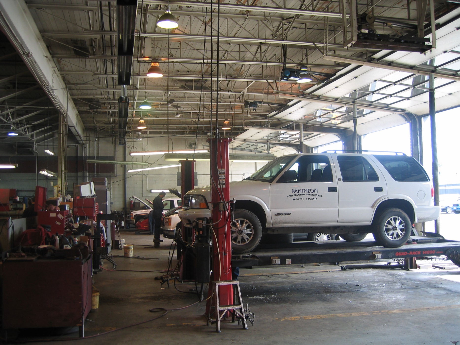 Infrared Industrial Heater Above Auto Shop with Cars Being Worked On