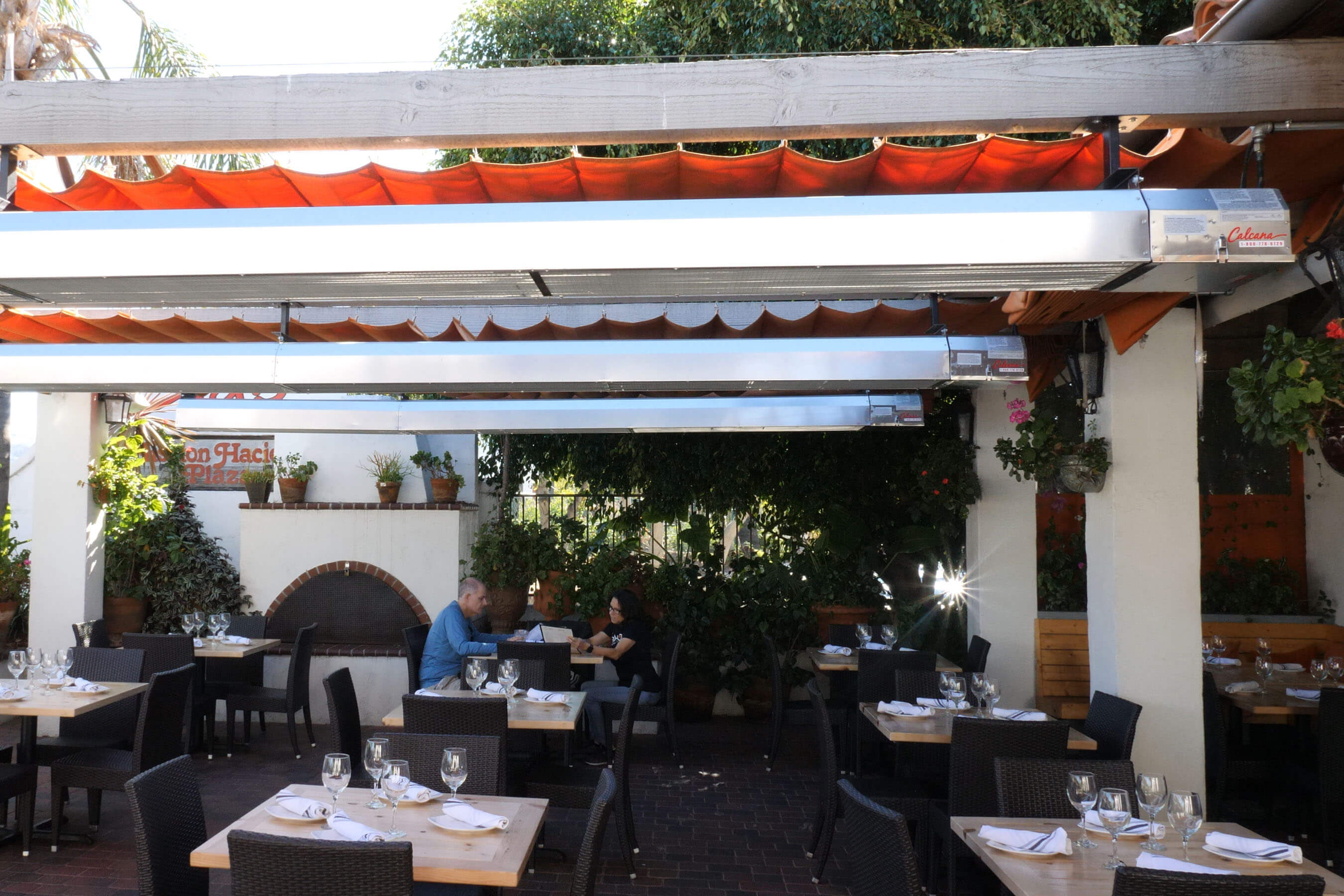 3 Infrared Patio Heaters keeping patio and people sitting warm