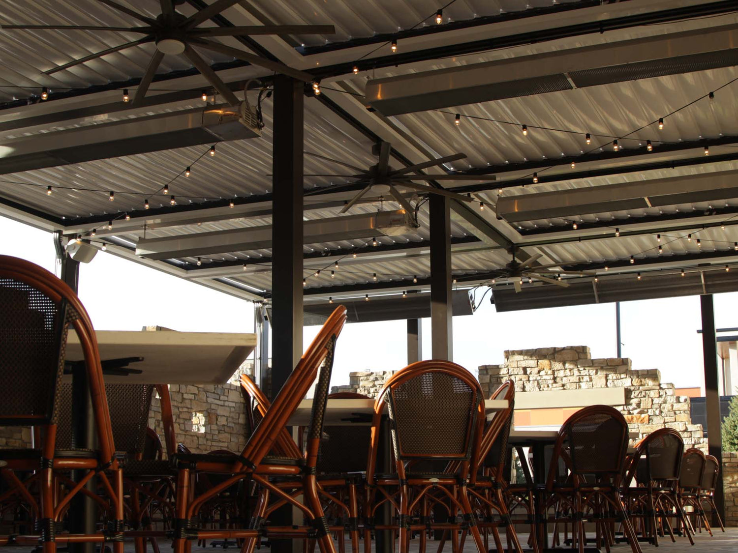 Infrared patio heater warming a busy restaurant terrace in the evening