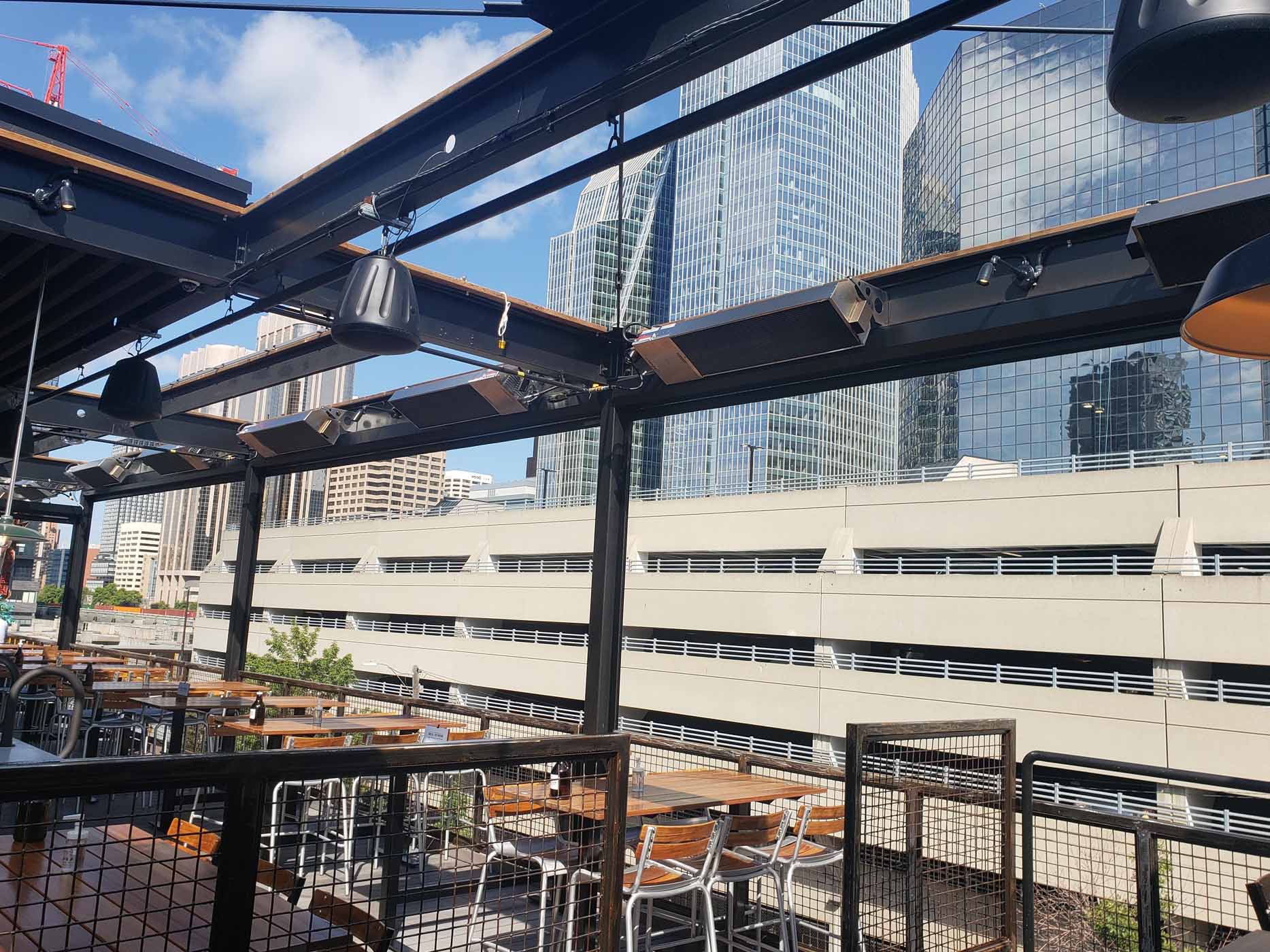 Calcana infrared patio heater installed on a wooden patio, providing radiant heat