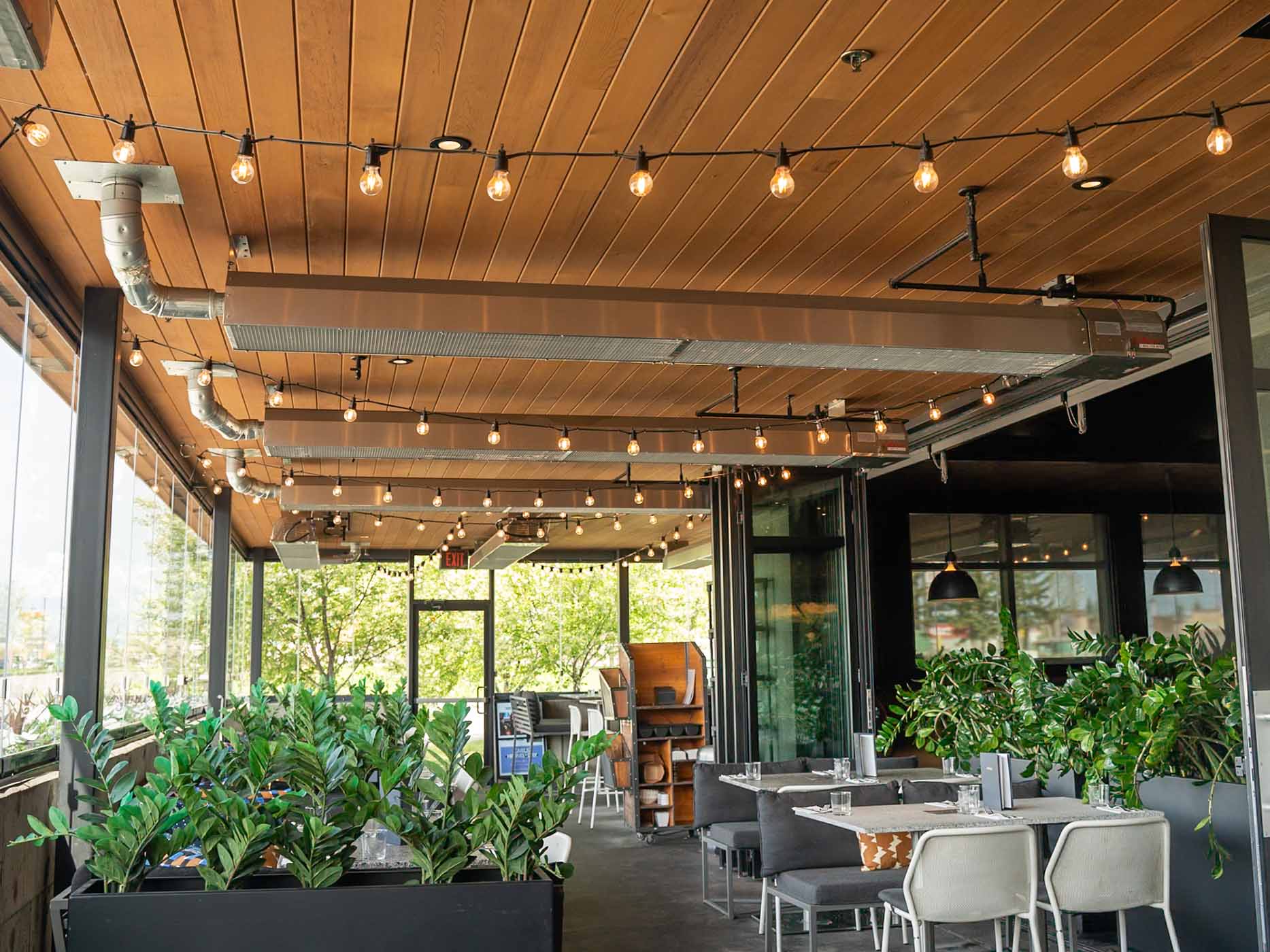 Ceiling-mounted infrared patio heaters warming an outdoor restaurant dining area