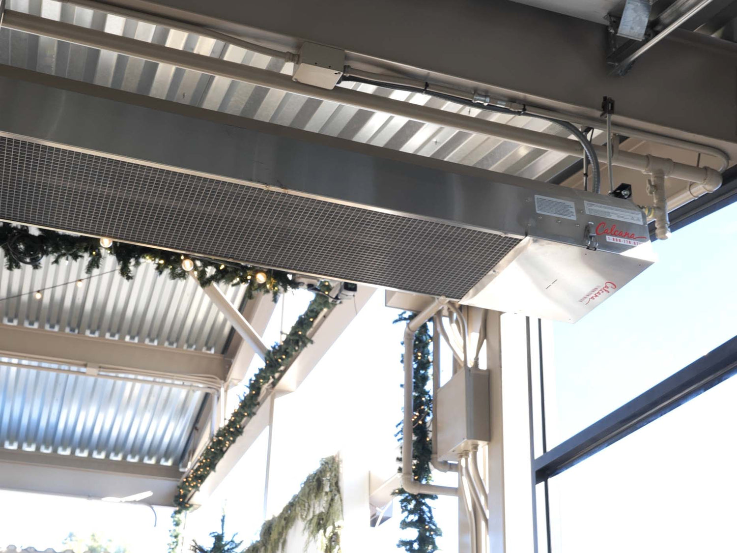 Infrared heater warming an outdoor patio area during the day